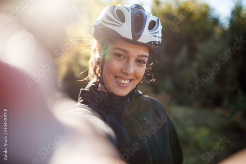 Fototapeta Naklejka Na Ścianę i Meble -  Happy active female cyclist make selfie