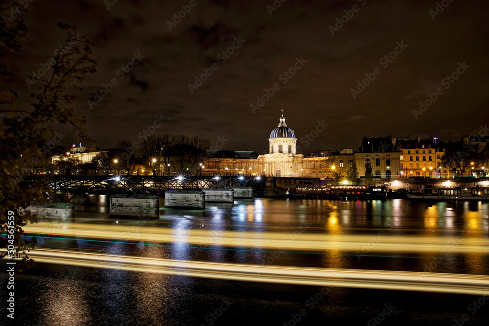 Paris, France - November 17, 2019: The Pont des Arts or Passerelle des Arts is a pedestrian bridge in Paris which crosses the Institut de France. With Institut de France in background