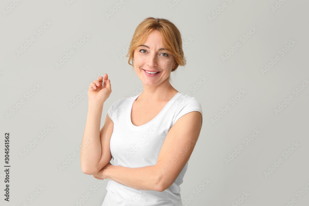 Beautiful mature woman on light background Beautiful mature woman on light background