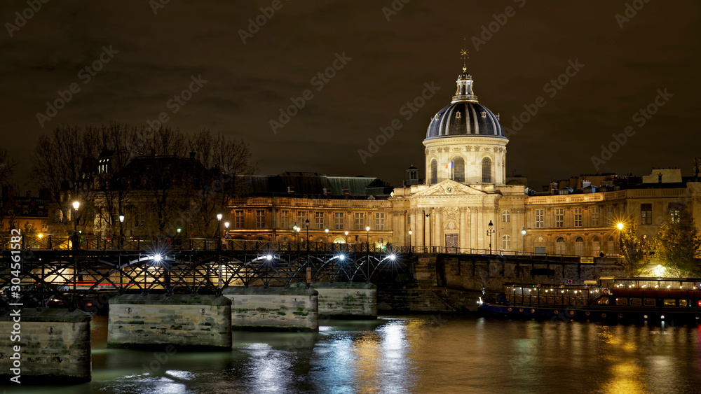 Paris, France - November 17, 2019: The Pont des Arts or Passerelle des Arts is a pedestrian bridge in Paris which crosses the Institut de France. With Institut de France in background