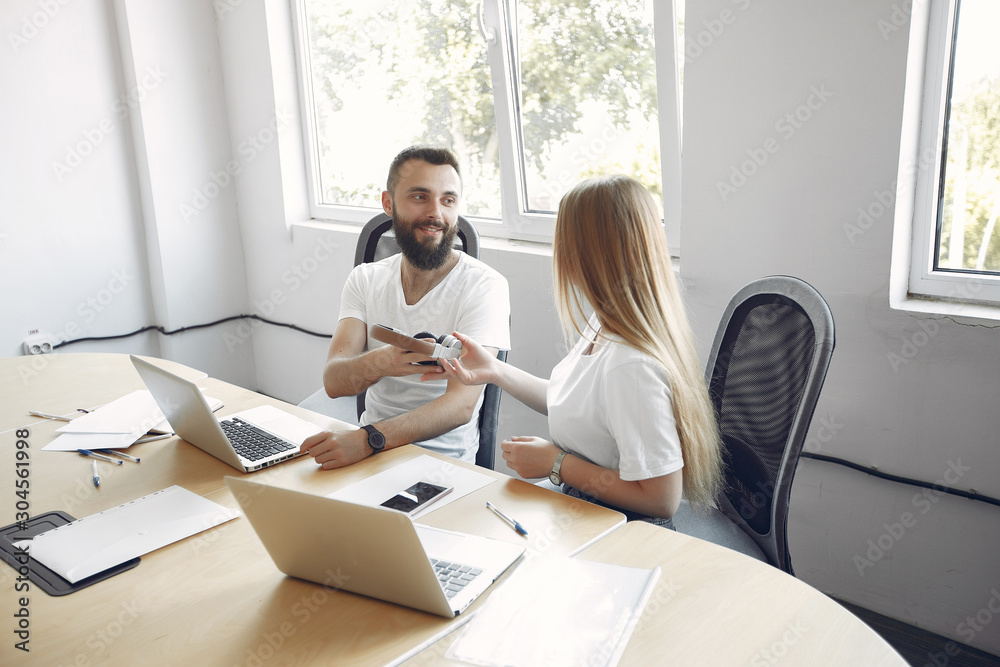 Students create a new project. Couple working in a office Students create a new project. Couple working in a office