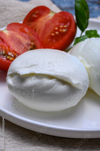 Cheese collection, organic mozzarella soft cheese served with ripe tomato and fresh green basil #304563945