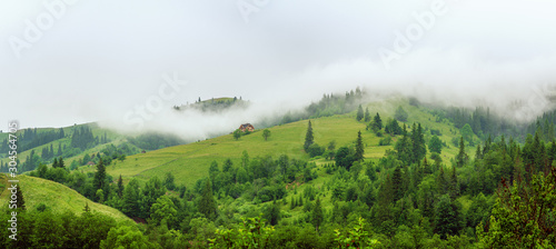 Little house on a green mountain slope