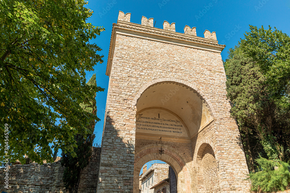 Assisi arch entrance Porta Nuova during sunny day.