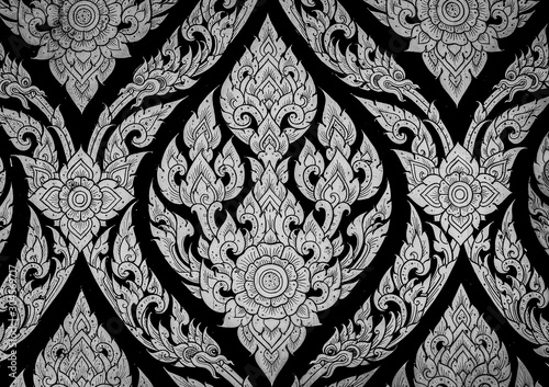 Closeup Thai pattern carving lotus picture at door in temple