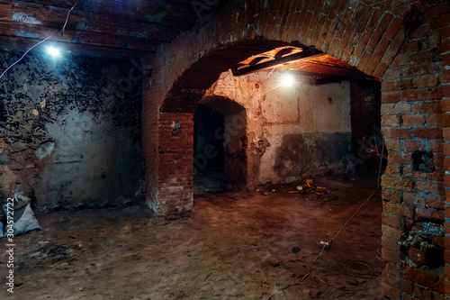 Abandoned empty old dark underground vaulted cellar