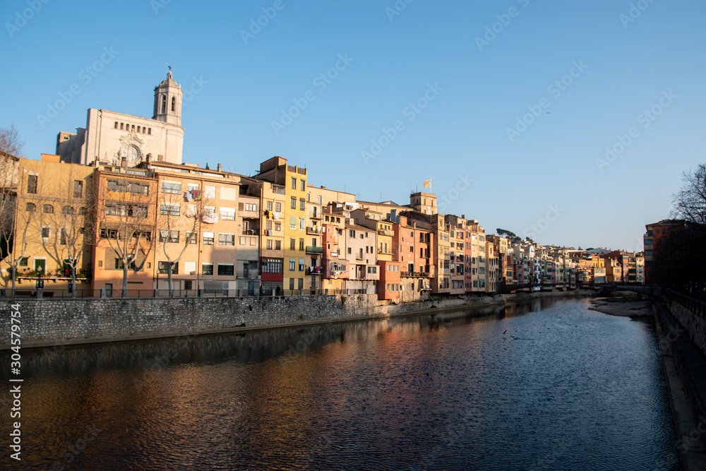 Looking at the riverside of Girona, Spain with the Cathedral of Girona in the background