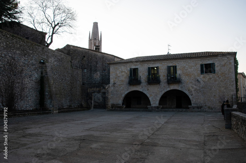  Girona’s Plaça dels Jurats is used for outdoor scenes of the theater in Braavos. Arya is watching the play that is about the Lannister while scoping for Jaquen H'gar photo
