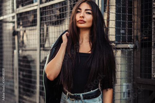 Pretty young sexy fashion woman posing on ventilators background.