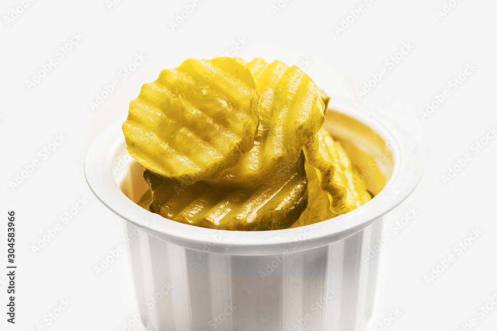 Sliced marinated pickled cucumbers isolated on white background. Sliced marinated pickled cucumbers isolated on white background.