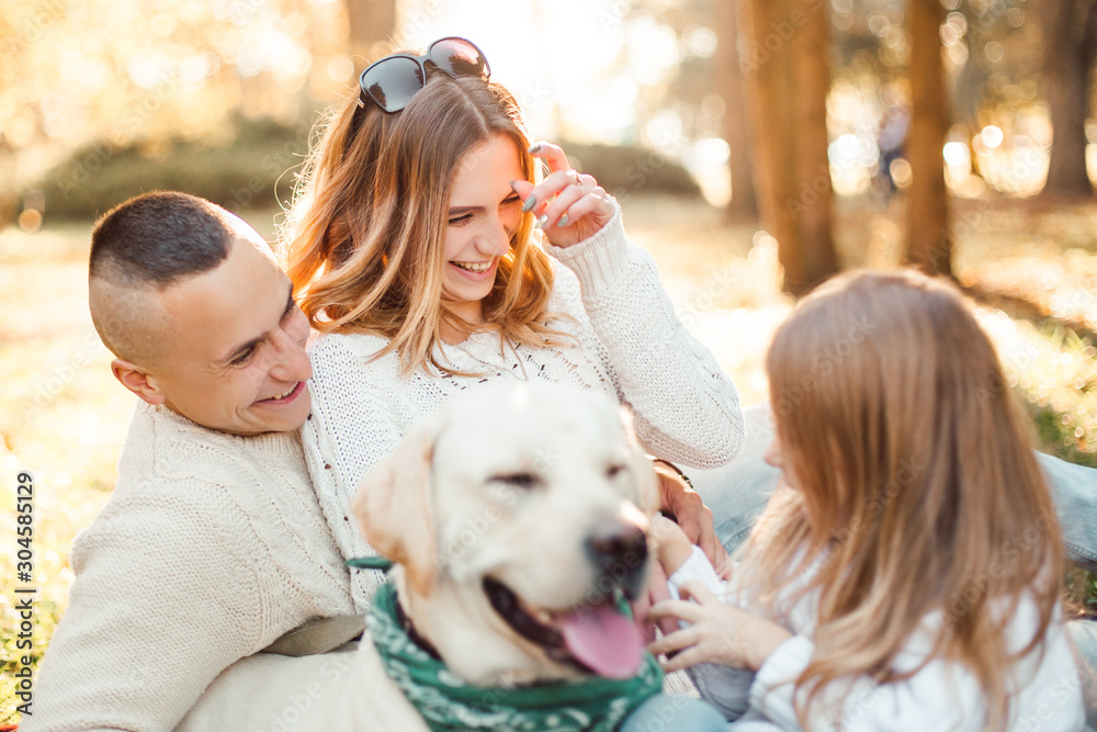 Happy family is having fun with dog labrador outdoors. Happy family is having fun with dog labrador outdoors.