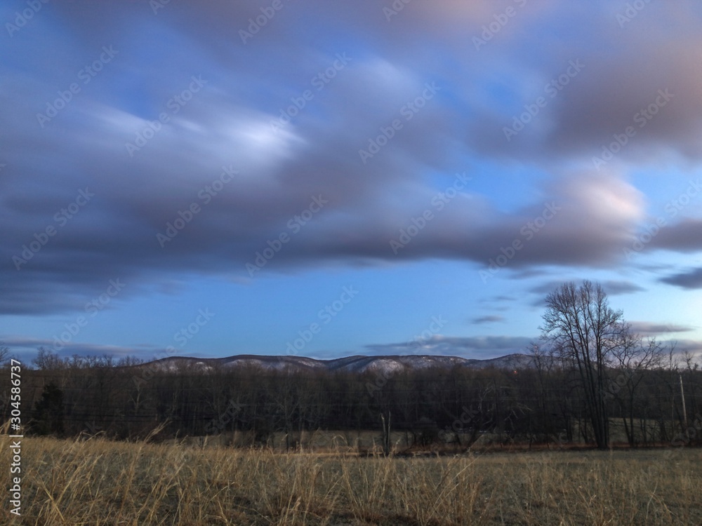 landscape with clouds and snow capped hills landscape with clouds and snow capped hills