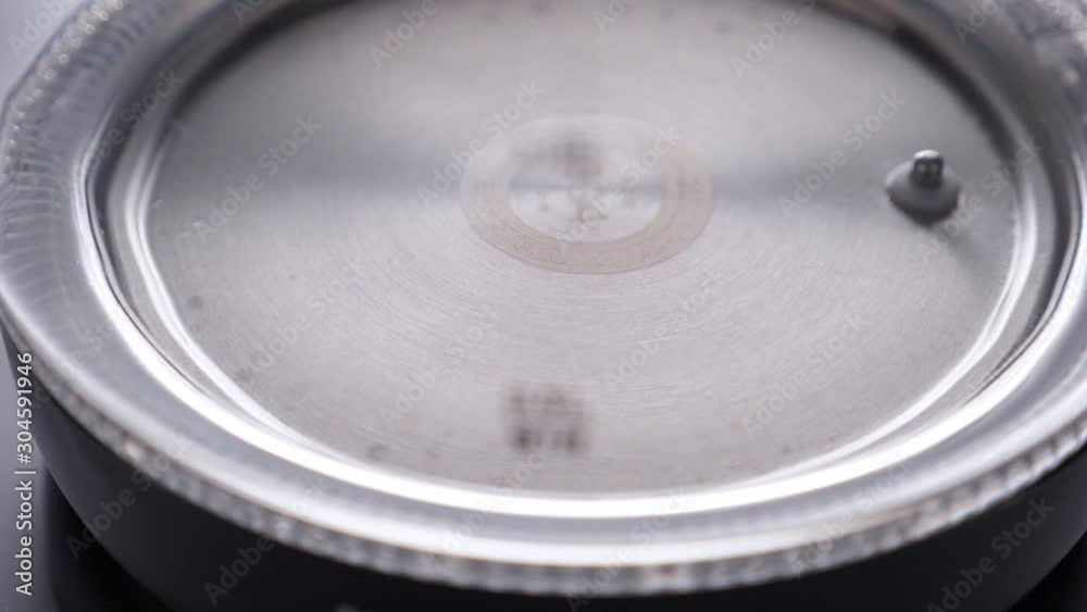 Pouring water in glass kettle on white background. Closeup. Nobody Pouring water in glass kettle on white background. Closeup. Nobody