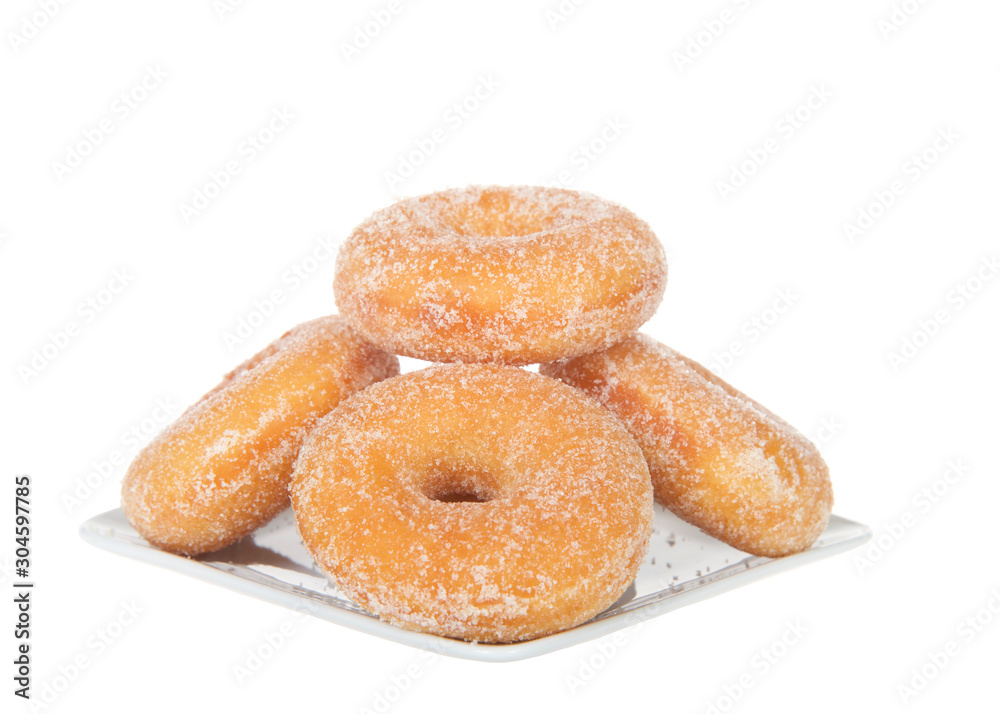 Square plate with sugar coated  donuts stacked, isolated on white