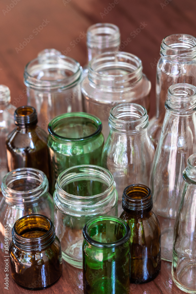 Variety shape and color of empty glass container bottles, reuse things concept Variety shape and color of empty glass container bottles, reuse things concept