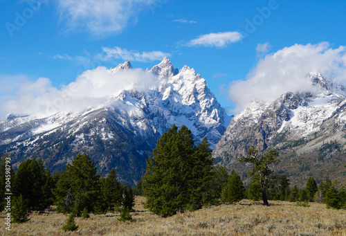 Clouds cling to the peaks of The Tetons on a beautiful autumn afternoon.