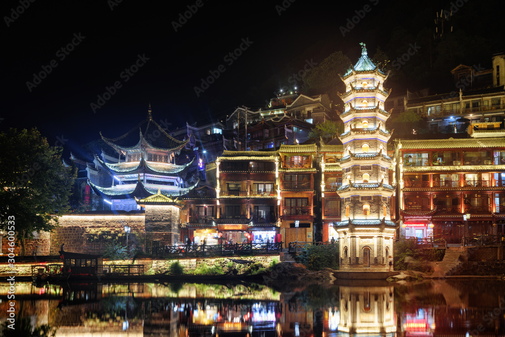 Fototapeta premium Scenic night view of the Wanming Pagoda, Phoenix Ancient Town