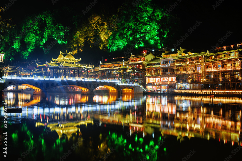 Night view of colorful bridge and traditional Chinese buildings
