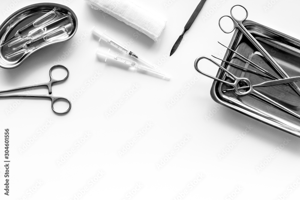 Fototapeta premium Plastic surgery instruments and tools with bandage on white background top view frame copy space