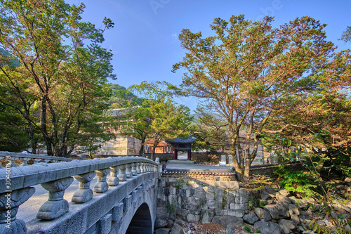 Scenic view of rock bridge and entrance to buddhistic temple in Jirisan national park in Republic of Korea. Beautiful summer sunny look of gate in asian style to religion object in South Korea photo