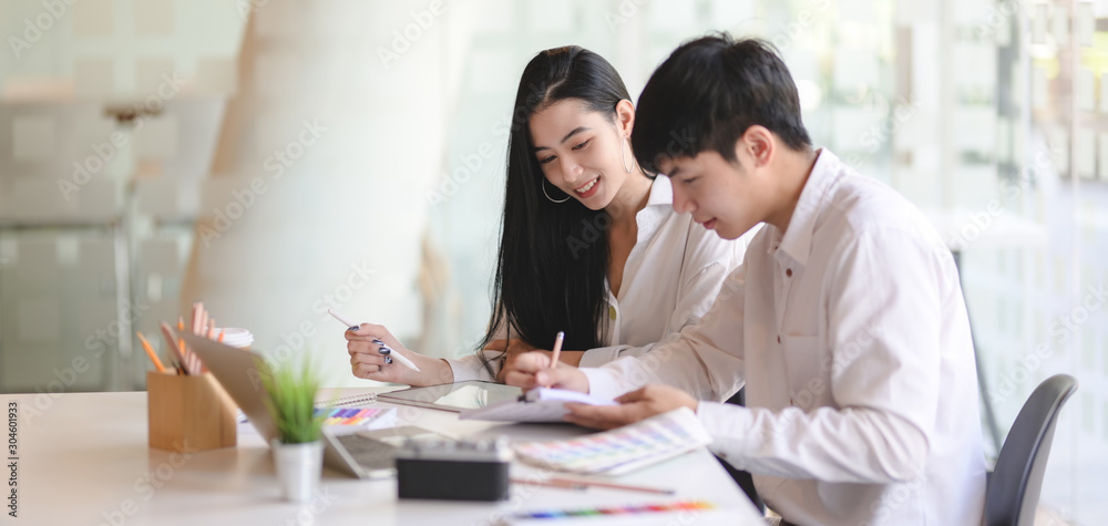 Group of young professional designer working on their project together in comfortable office Group of young professional designer working on their project together in comfortable office