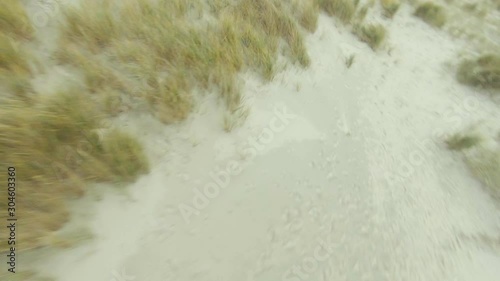 Drone flying low over the dunes at a Dutch beach, with a quick turn in the end.