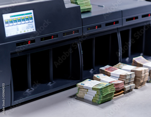 Fototapeta Naklejka Na Ścianę i Meble -  Banknote counting machine with money in front of it