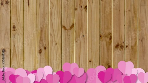 Pink heart sign on wooden background