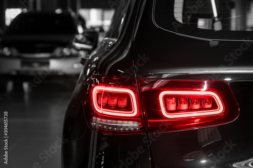 Close-up taillight of a new halogen black crossover car. Exterior of a modern car. Close up detail on one of the LED lights modern car.