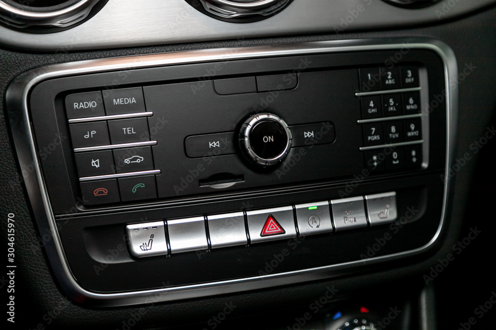 Audio stereo system, control panel and cd in a modern car. Car control panel of audio player and other devices..A shallow depth of field close up of the control panel of a car. .