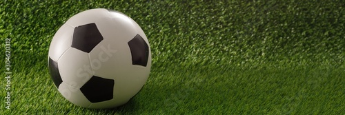 Soccer ball on the green field. The concept of football matches. Copy space. Banner.