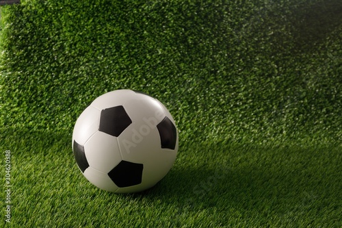 Soccer ball on the green field. The concept of football matches. Copy space. Close-up.