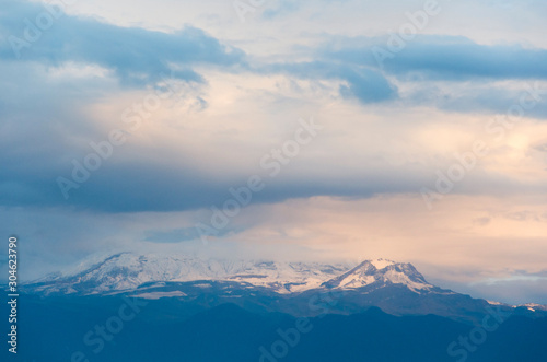 Nevado del Ruiz, a Colombian snow-covered volcano, under a cloudy sky