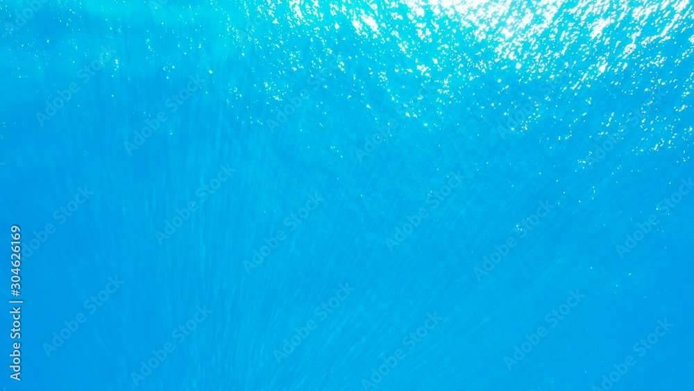 beautiful azure water texture with sun reflection. Tropical deep sea with corals beautiful azure water texture with sun reflection. Tropical deep sea with corals
