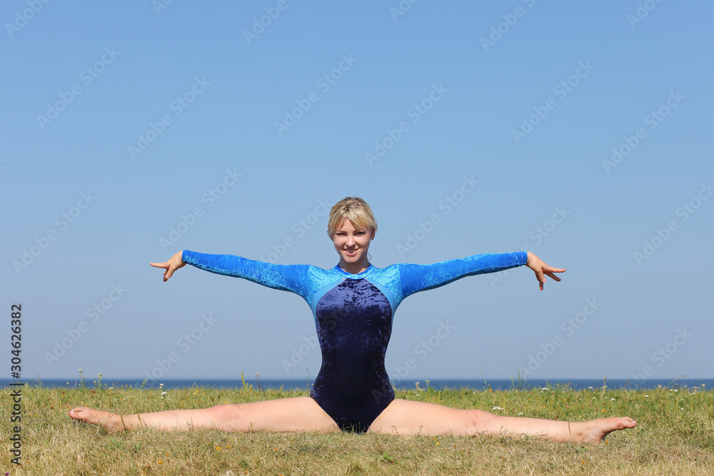 girl gymnast in a blue bodysuit girl gymnast in a blue bodysuit