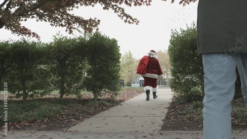 Santa Claus Walking through a Park