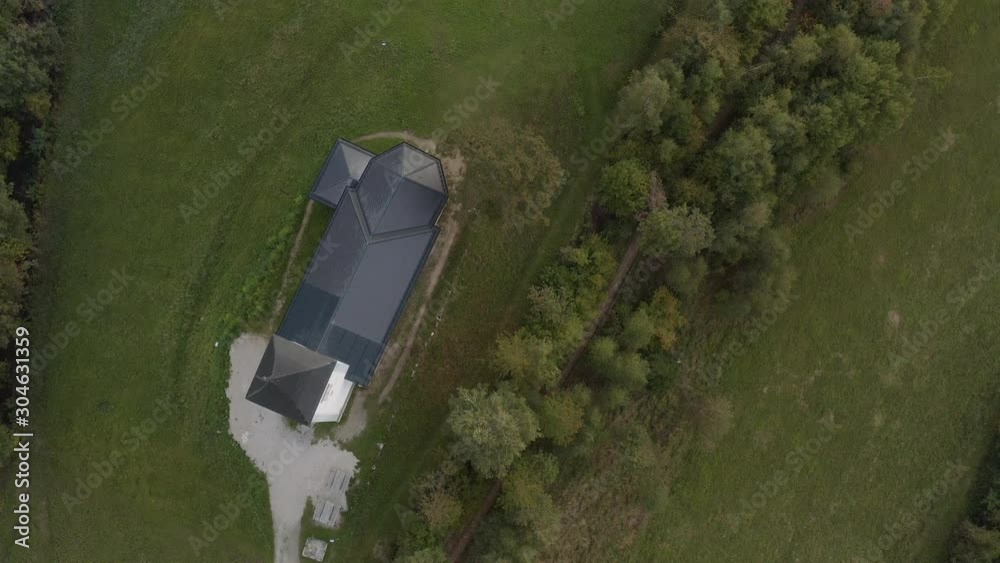 Jamnik, Slovenia - Aerial view the church of St. Primoz in Slovenia near Jamnik with beautiful clouds and Julian Alps at background