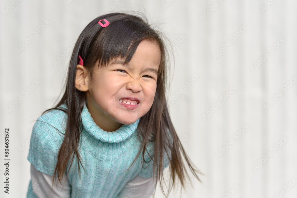 Fun loving little girl tossing her long hair Fun loving little girl tossing her long hair