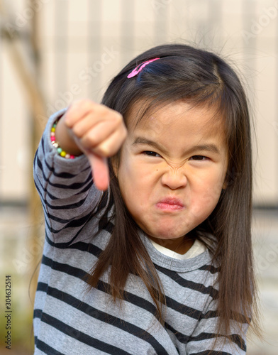 Angry frustrated girl throwing a temper tantrum © michaelheim