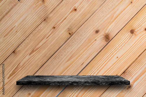 Empty top of black marble stone table on wooden plank wall background. For product display photo