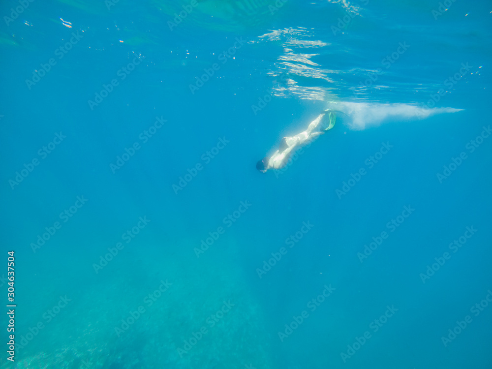 woman in flipper view underwater beach vacation