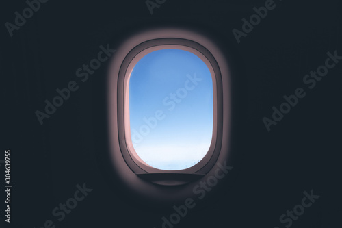 Airplane window. Glass in focus sky blurry