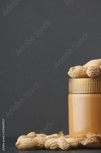 Peanut butter with the peanuts over black background.this peanut also kown as ground nut. selective focus photo
