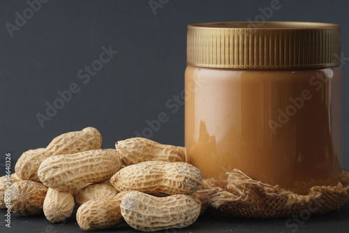 Peanut butter with the peanuts over black background.this peanut also kown as ground nut. selective focus photo