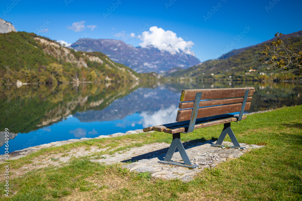 Lago di Cavedine beautiful lake. Wooden bench in focus. Italy. Arco Lago di Cavedine beautiful lake. Wooden bench in focus. Italy. Arco