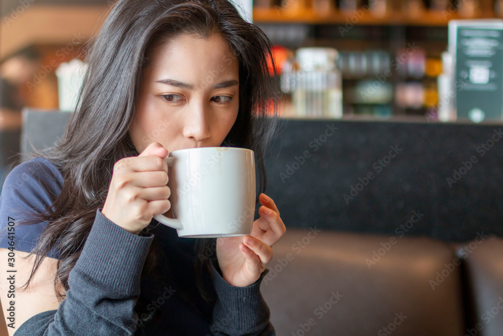 Young beautiful girl holding a cup of coffee in cafe. Outdoor portrait of young beautiful woman posing while traveling holiday vocation. Girl with coffee. Female traveler, travel vacation fun summer. Young beautiful girl holding a cup of coffee in cafe. Outdoor portrait of young beautiful woman posing while traveling holiday vocation. Girl with coffee. Female traveler, travel vacation fun summer.
