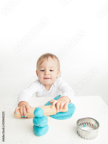 Young child playing with play doh or play dough 