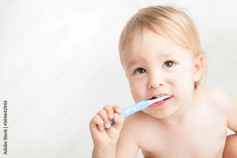 Little boy brushing his teeth on white background Little boy brushing his teeth on white background