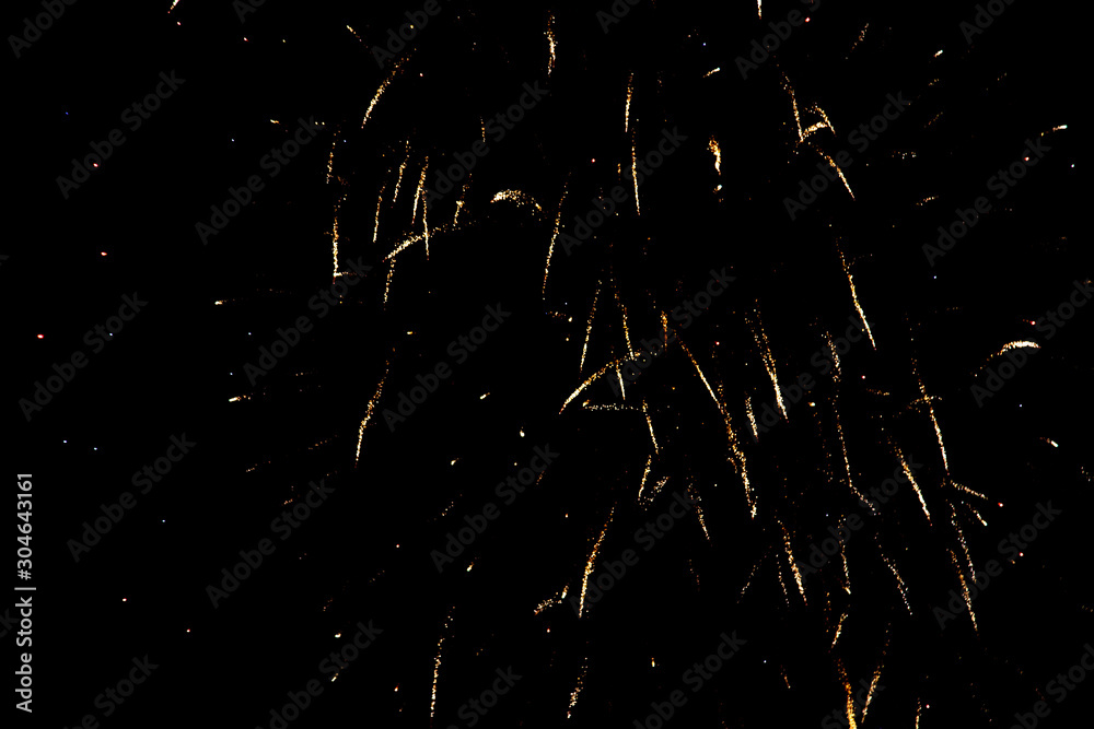 Fireworks sparkles in the night sky as background