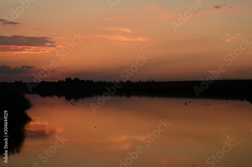 Sunset grass on river sunset landscape © Oleksandr